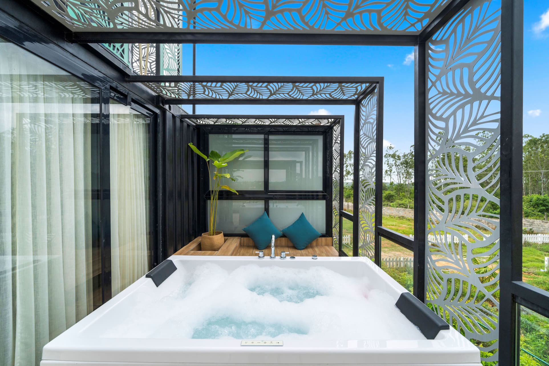 Open-sky jacuzzi framed by ornate laser-cut pergola screens